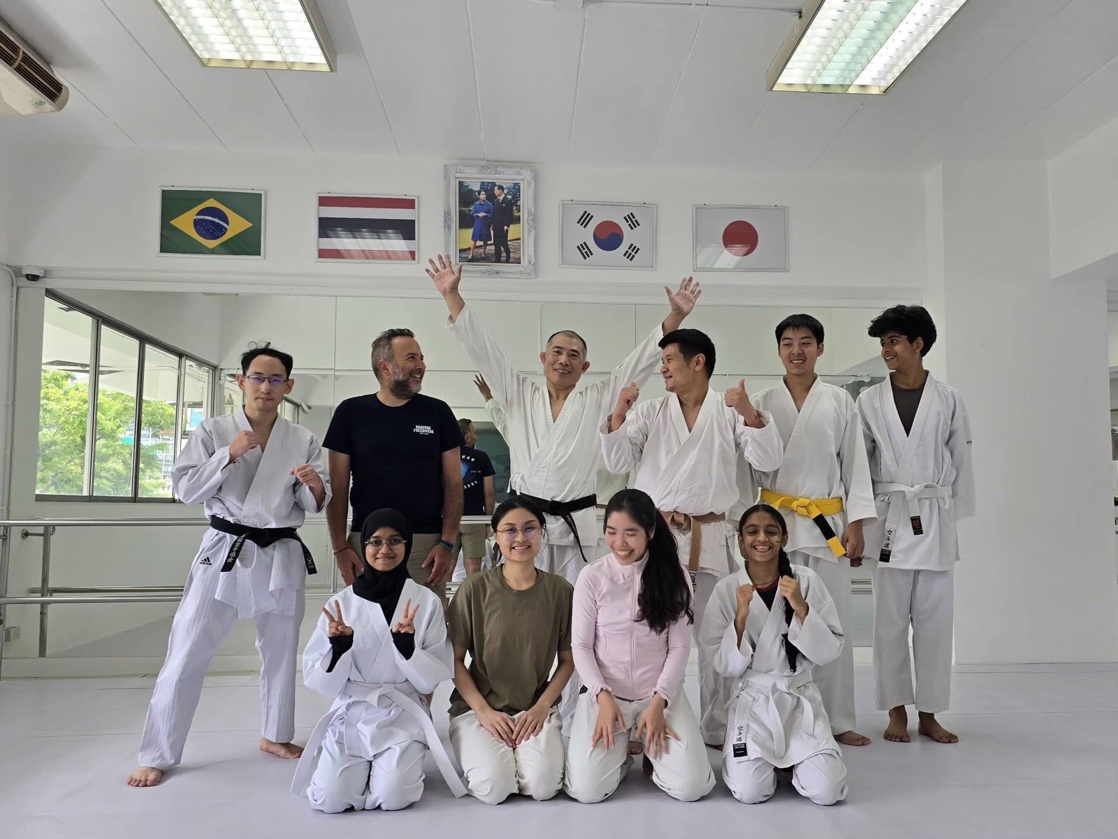 EMAC members and instructors in the dojo, some in karate uniforms