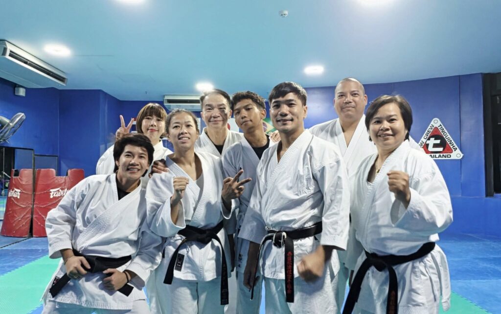 Members of Ippo-Kan Dojo in karate uniforms and black belts