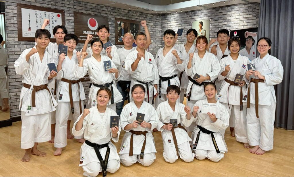 Boy Gym members holding their new grade certificates after passing the examination