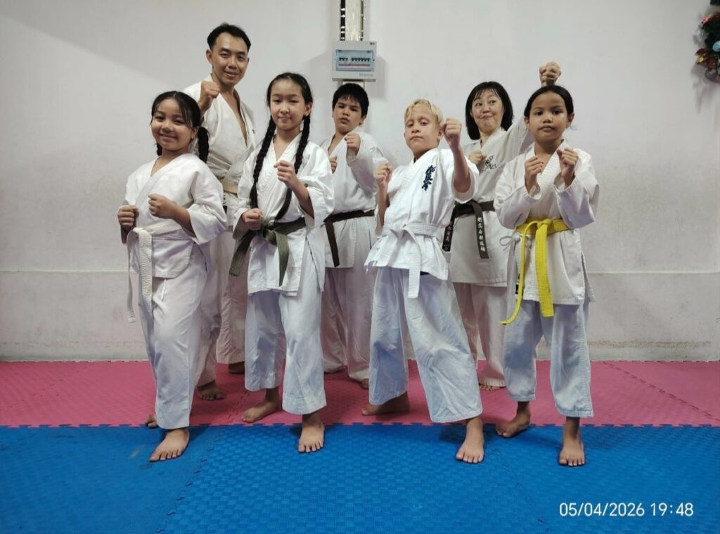 Children and instructors of Phuket Karate Center in karate stances