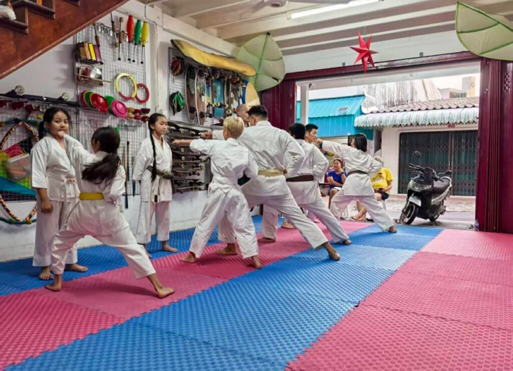 Students practising stances during a group class