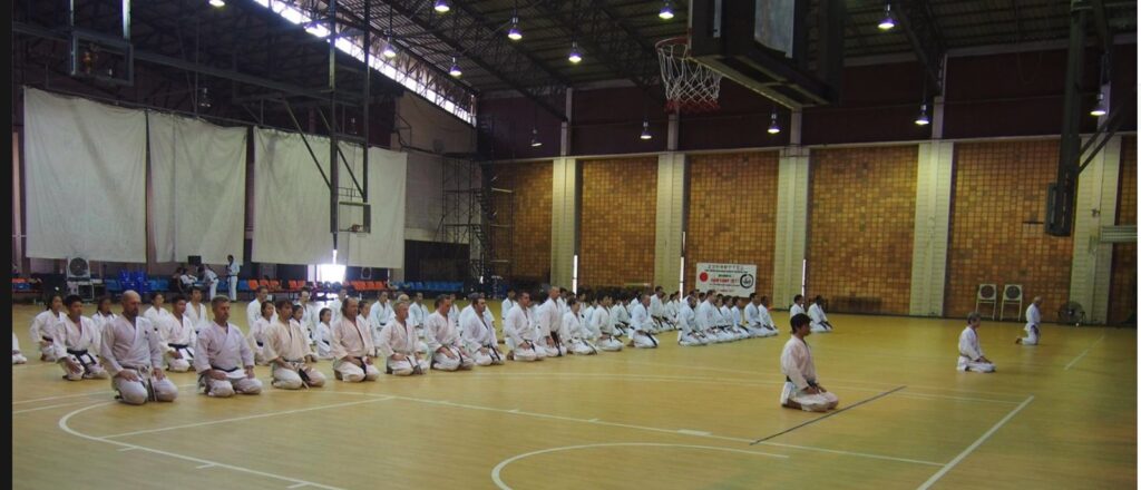 Participants seated in a line in a large hall